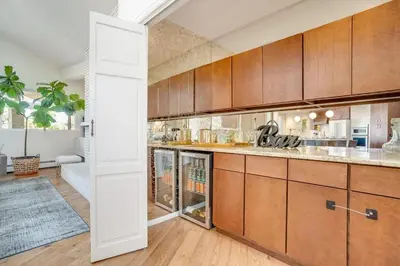 a kitchen with wooden cabinets and a large counter at Mid-Century Mod - 7 BR Sleeps 22 - Hot Tub & Game Room in Westminster