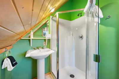 a bathroom with a shower and a sink at Peaks Perch home in Granby