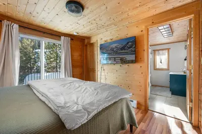 a bedroom with a large bed and a window at Peaks Perch home in Granby
