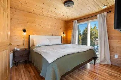 a bedroom with a bed in a wooden cabin at Peaks Perch home in Granby