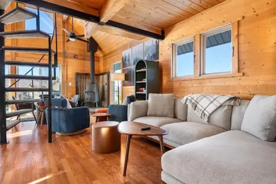 a living room with a couch and a table at Peaks Perch home in Granby