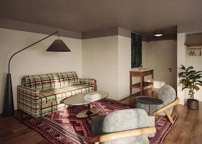 a living room with a couch and a table at All Inn in Denver