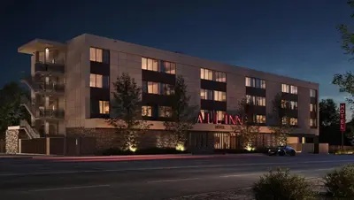 a building with an illuminated sign on the side of it at All Inn in Denver
