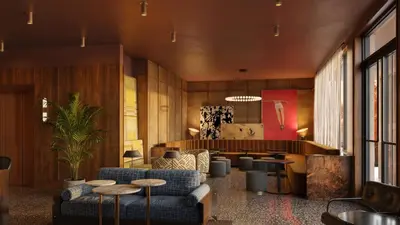 a lobby with couches and tables and a bar at All Inn in Denver