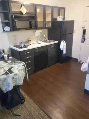 a small kitchen with a sink and a refrigerator at Sonesta simply suites in Lakewood
