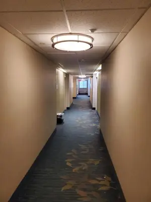 an empty hallway in an office building with a light fixture at Sonesta simply suites in Lakewood