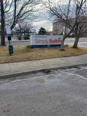 a sign for a snesssasimply suites on the side of a street at Sonesta simply suites in Lakewood