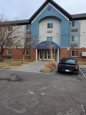 a car parked in a parking lot in front of a building at Sonesta simply suites in Lakewood