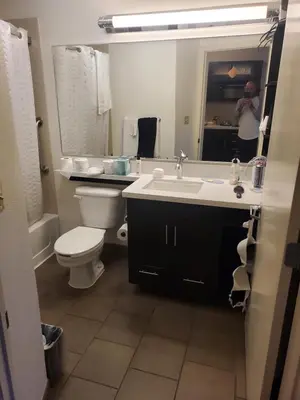 a bathroom with a sink and a toilet and a mirror at Sonesta simply suites in Lakewood