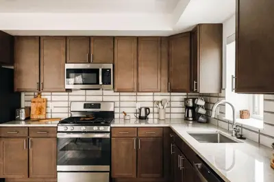 a kitchen with wooden cabinets and stainless steel appliances at Refined Riverfront Living - King Suite & Views in Silverthorne