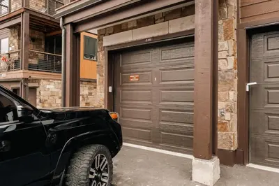 a car parked in front of two garage doors at Refined Riverfront Living - King Suite & Views in Silverthorne