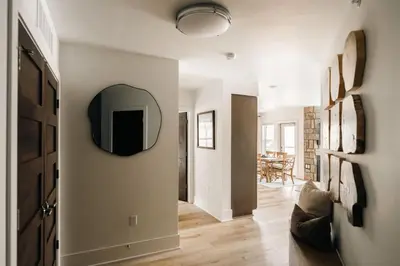 a living room with a mirror on the wall at Refined Riverfront Living - King Suite & Views in Silverthorne