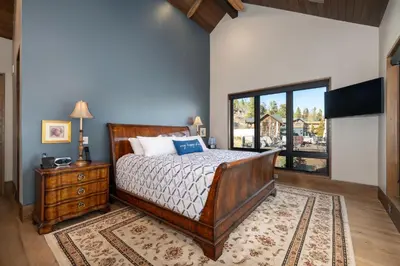 a bedroom with a bed and a large window at LP Lakefront House - Private Dock, 7000+ Square Feet of Space, Stunning Views, Impeccable Quality in Grand Lake