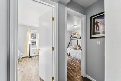 a room with a bed and a door with a mirror at Treehouse C106 - Renovated Condo with Great Amenities, Central Summit County Location in Silverthorne