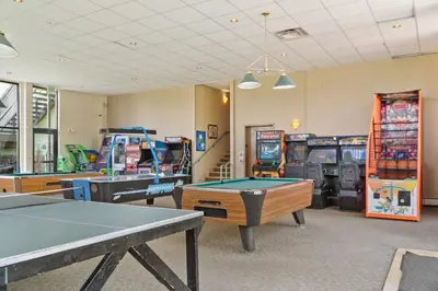 a gaming room with ping pong tables and video games at Treehouse C106 - Renovated Condo with Great Amenities, Central Summit County Location in Silverthorne