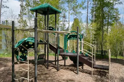 a playground with a slide in a park at Treehouse C106 - Renovated Condo with Great Amenities, Central Summit County Location in Silverthorne