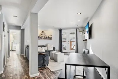 a living room with a table and a couch at Treehouse C106 - Renovated Condo with Great Amenities, Central Summit County Location in Silverthorne