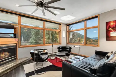 a living room with a couch and chairs and a fireplace at River Bank Lodge 2916 in Snake River Health Services Incorporated Heliport
