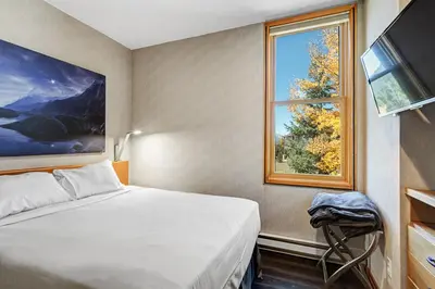 a bedroom with a bed and a window at River Bank Lodge 2916 in Snake River Health Services Incorporated Heliport