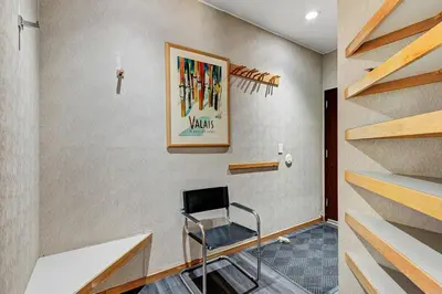 a room with a chair in a room with stairs at River Bank Lodge 2916 in Snake River Health Services Incorporated Heliport