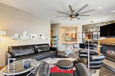 a living room with a black leather couch and chairs at River Bank Lodge 2916 in Snake River Health Services Incorporated Heliport