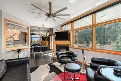 a living room with black leather chairs and a tv at River Bank Lodge 2916 in Snake River Health Services Incorporated Heliport