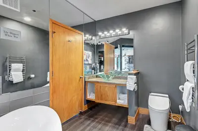 a bathroom with a sink and a toilet and a mirror at River Bank Lodge 2916 in Snake River Health Services Incorporated Heliport