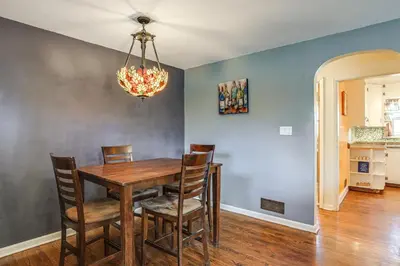 a dining room table with chairs and a chandelier at Explore the Front Range! Lakewood Home with Yard in Lakewood
