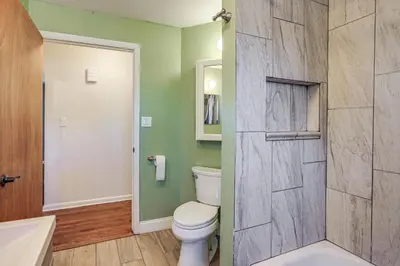 a bathroom with a white toilet and a shower at Explore the Front Range! Lakewood Home with Yard in Lakewood