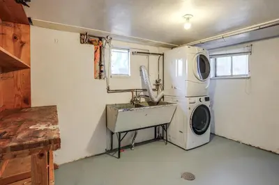 a kitchen with a sink and a washing machine at Explore the Front Range! Lakewood Home with Yard in Lakewood