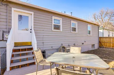 a house with a table and chairs in front of it at Explore the Front Range! Lakewood Home with Yard in Lakewood