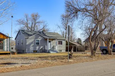 a house sitting on the side of a street at Explore the Front Range! Lakewood Home with Yard in Lakewood