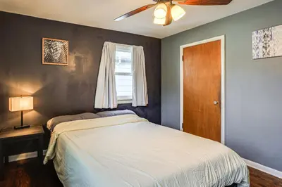a bedroom with a large bed and a window at Explore the Front Range! Lakewood Home with Yard in Lakewood