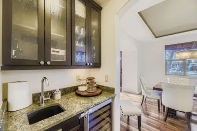 a kitchen with a sink and a dining room at 6BR Luxury Denver Retreat-Sleeps -14 - 7 Baths in Denver