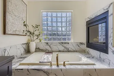 a bathroom with a tub and a window and a sink at 6BR Luxury Denver Retreat-Sleeps -14 - 7 Baths in Denver