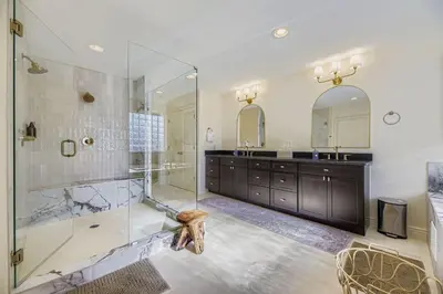 a bathroom with a walk in shower and a sink at 6BR Luxury Denver Retreat-Sleeps -14 - 7 Baths in Denver
