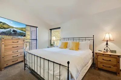 a bedroom with a bed and a dresser and a window at Hygge Haus - 2BD Lake View & Pet Friendly Retreat in Dillon