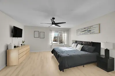 a bedroom with a bed and a ceiling fan at Your Home Away From Home ! in DEN