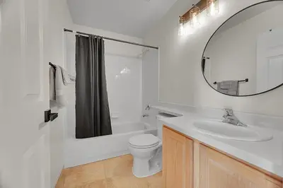 a bathroom with a sink and a toilet and a mirror at Your Home Away From Home ! in DEN