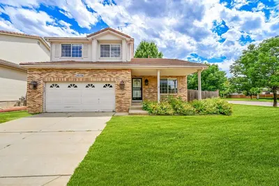 a house with a grass yard in front of it at Your Home Away From Home ! in DEN