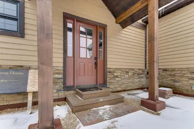 a front door of a house in the snow at Ride-InandRide-Out Grand Lake Hub Near Lakes and RMNP in Grand Lake