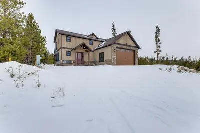 a house in the snow in front at Ride-InandRide-Out Grand Lake Hub Near Lakes and RMNP in Grand Lake