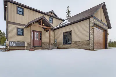 a house with a garage in the snow at Ride-InandRide-Out Grand Lake Hub Near Lakes and RMNP in Grand Lake