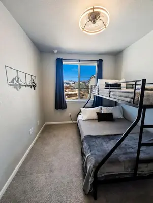 a bedroom with a bunk bed and a window at Cozy Mountain View Getaway! in Arvada