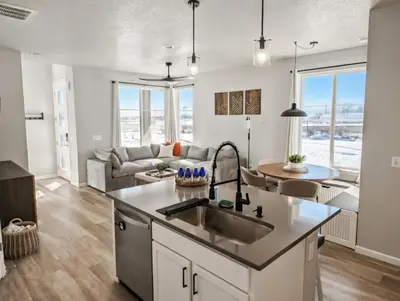 a kitchen and living room with a sink at Cozy Mountain View Getaway! in Arvada