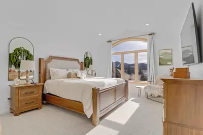 a bedroom with a bed and a large window at Pedal and Peak 113A townhouse in Dillon