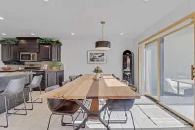 a kitchen and dining room with a wooden table and chairs at Pedal and Peak 113A townhouse in Dillon