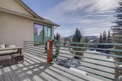a deck with a view of the mountains at Pedal and Peak 113A townhouse in Dillon