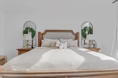 a white bed with a teddy bear sitting on it at Pedal and Peak 113A townhouse in Dillon