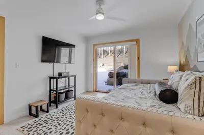 a bedroom with a large bed and a television at Pedal and Peak 113A townhouse in Dillon